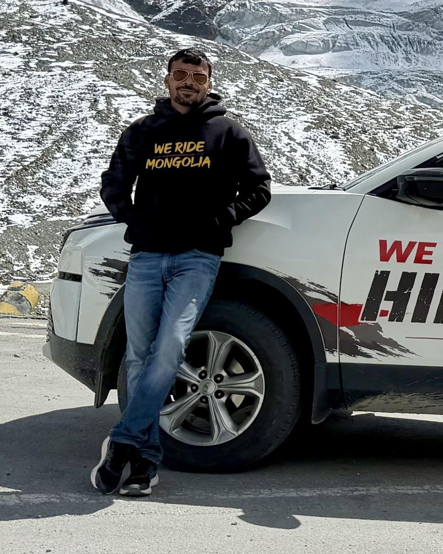 Ajay, the organizer of We Ride Mongolia, in a We Ride Mongolia hoodie in the Himalayas