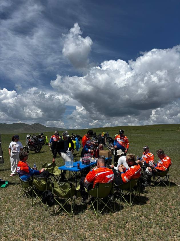 Riders enjoying a lunch stop on the open grassland