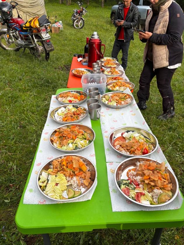 Camp meal laid out on a green table