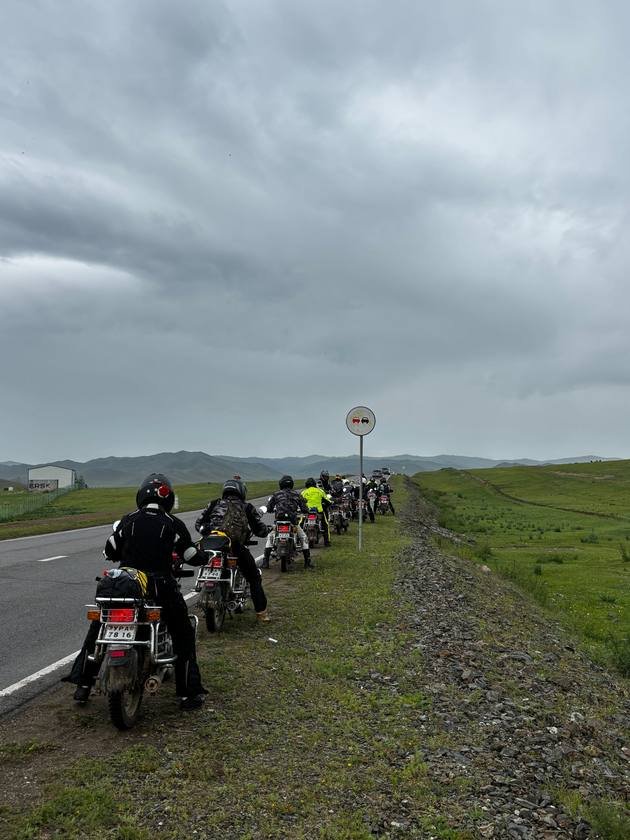 Motorcycles lined up along a Mongolian road